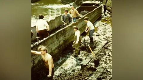 Canal & River Trust People working to clear mud at the Ellesmere Port site in the 1970s