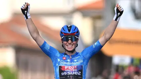Demi Vollering celebrates at the finish line after clinching the overall victory in the women's Giro d'Italia of 2026