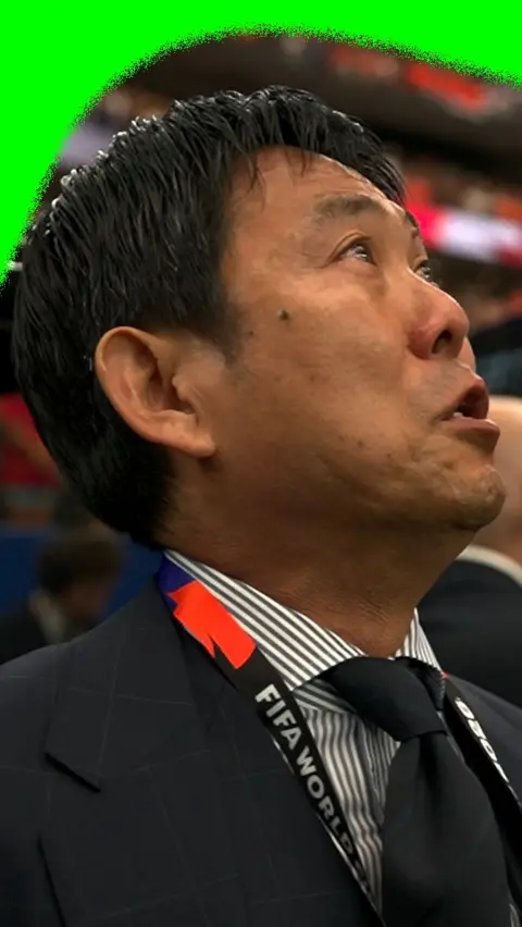 Japanese supporter emotional while singing national anthem during 2026 World Cup match against Netherlands.