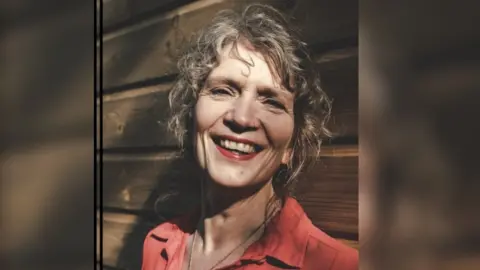 University of Plymouth Clare Pettinger - a middle aged woman with fair hair and red blouse