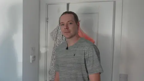 Oliver stood in his bedroom in Didcot.