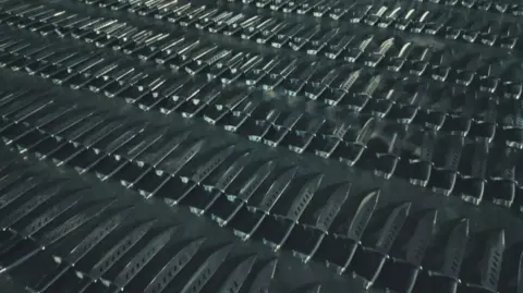 Bedfordshire Police/Channel 4 Rows of hundreds of zombie-style knives laid out on the floor