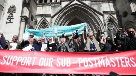 A group of sub-postmasters outside court