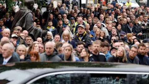 Reuters Mourners look on as the funeral cortege of Ricky Hatton passes.