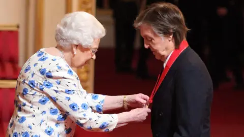 PA The Queen and Paul McCartney