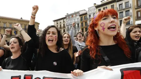 AFP Protesters raise their arms in Pamplona on April 28, 2018, in the third day of demonstrations after five men were cleared of rape