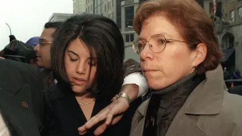 Getty Images Monica Lewinsky being escorted through a media scrum in Washington in 1999