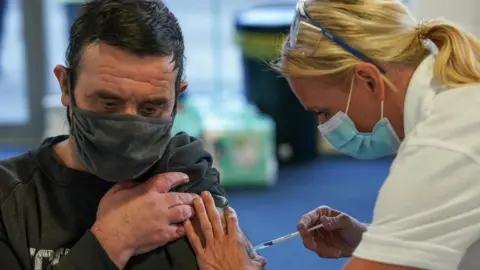 Getty Images Man being vaccinated