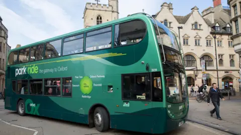Green park and ride bus in Oxford City, England, United Kingdom. This bus scheme encourages people to park their cars outside the city centre to reduce congestion.