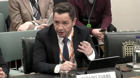 House of Commons Geraint Evans addressing the Welsh Affairs Committee, gesturing with his hand.