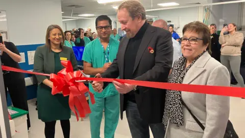 Kevin cuts the ribbon at a celebration event for the re-opening of the Interventional Radiology theatres