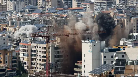 EPA Smoke rises after an Israeli airstrike targets the southern suburbs of Beirut.