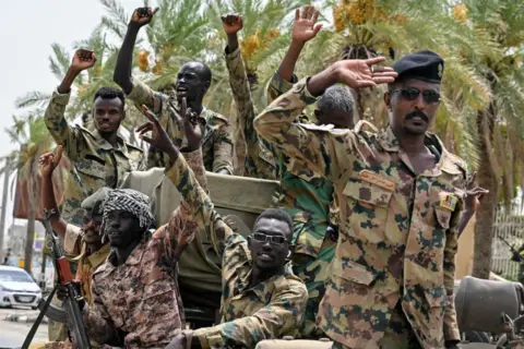 AFP Members of the Sudanese armed forces take part in a military parade held to mark Army Day outside the Armed Forces Officers Club in Port Sudan on August 14.