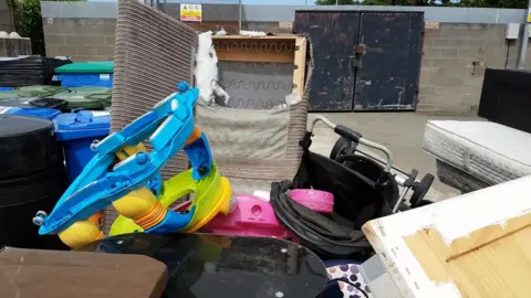 Denbighshire County Council A pile of illegally-dumped rubbish in Denbighshire