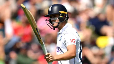 England batter Jacob Bethell raises his bat as he walks off after being dismissed for 96 in second Test against New Zealand in Wellington