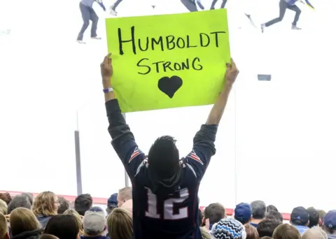 A fan holds up a sign in support of the Humboldt Broncos during third period action between the Winnipeg Jets and the Chicago Blackhawks at the Bell MTS Place on April 7, 2018 