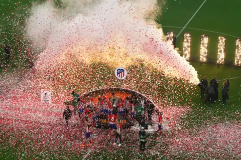 Catherine Ivill/Getty Images Atletico Madrid players lift The Europa League trophy after the UEFA Europa League Final between Olympique de Marseille and Club Atletico de Madrid at Stade de Lyon on 16 May 2018 in Lyon, France.