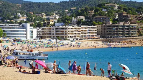 Getty Images Holidaymakers on Spanish beach