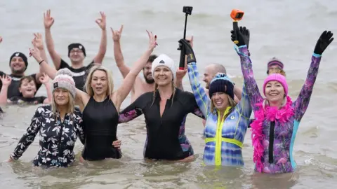 PA Media Gosport swimmers in fancy dress on New Year's Day