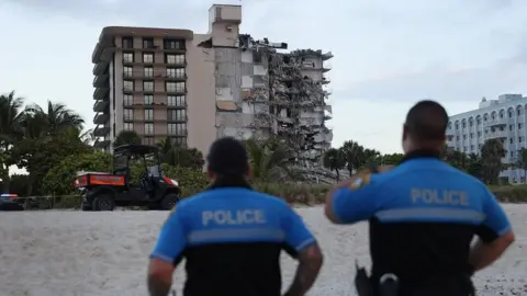 Getty Images A portion of the 12-story condo tower crumbled to the ground during a partially collapse of the building on June 24, 2021 in Surfside, Florida