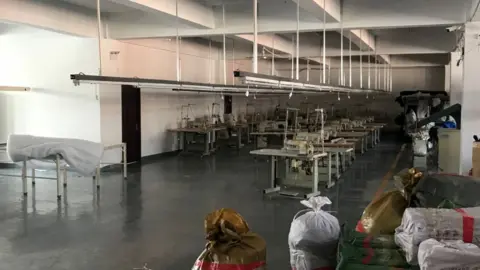 Getty Images An unused garment factory in the Dandong New District Innovation Institute in Dandong, in China's northeast Liaoning. The factory, started by a Chinese owner, is mostly empty after his North Korean workers returned home after UN sanctions came into effect.