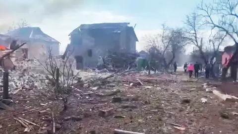 Reuters/Armed Forces of Ukraine The aftermath of Russian artillery shelling on a residential area in Mariupol, 10 March