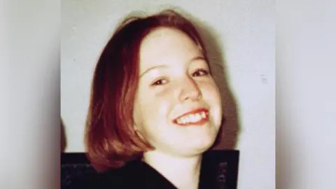 PA Media Leah Betts has short, shoulder-length hair that is light brown. She is smiling and wearing a black top.