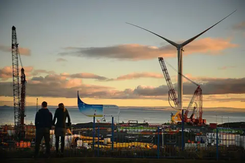 Getty Images Two people look across the yard at Methil in 2013 when the yard was used for testing a large and powerful wind turbine.