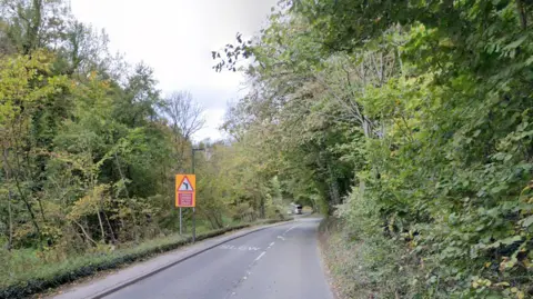 The A5012 running through a wooded area