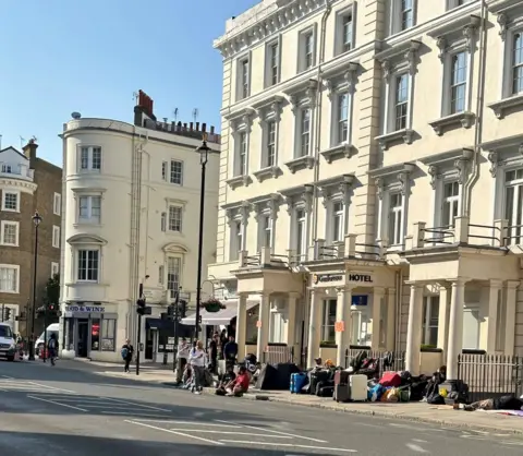 Rachael Burford/Evening Standard Asylum seekers camped outside hotel