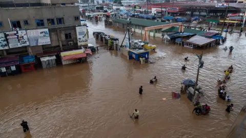 EPA View from above of people walking through the floodwater
