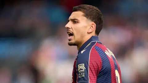 Matias Moreno in red and blue striped Levante kit