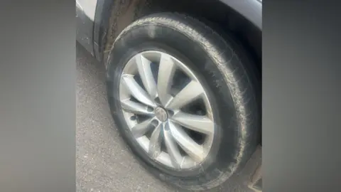 Lauren James A close-up photo of Lauren's tyre which has a ring of mud around it.