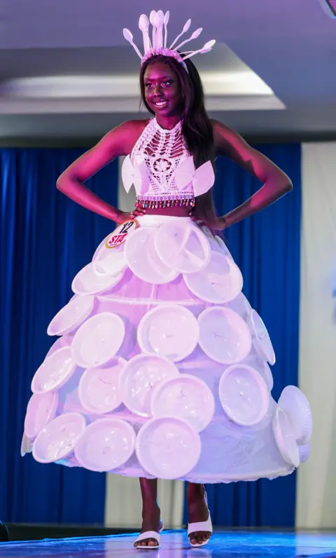 Daniel Irungu / EPA A model wearing a dress inspired by paper plates and cutlery poses at the 11th South Sudan Theater Awards 2024 (STA) held in Nairobi, Kenya on Wednesday, December 18, 2024. Show off your work.