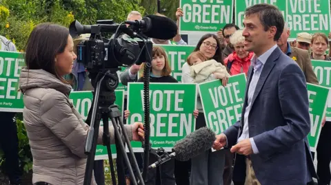 Paul Moseley/BBC Adrian Ramsay being interviewed by a reporter
