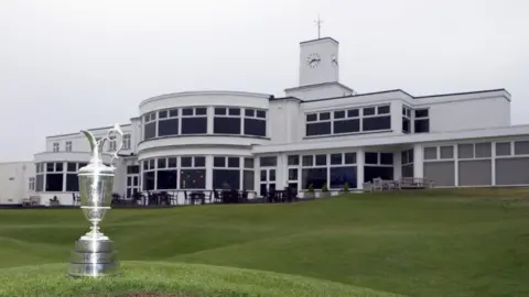 The Claret Jug on display on the grass in front of the club house during a media day for the 154th Open at Royal Birkdale, Southport.