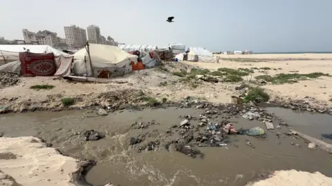 Makeshift tents stand right by sewage in Gaza. 