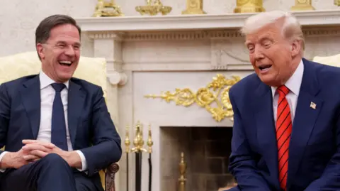 Getty Images Mark Rutte (L) sits beside Donald Trump in the White House.