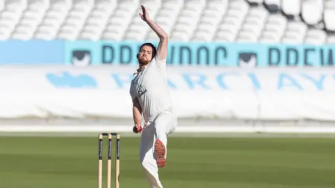 Ryan Higgins in mid-delivery stride bowling for Middlesex against Gloucestershire at Lord's last season