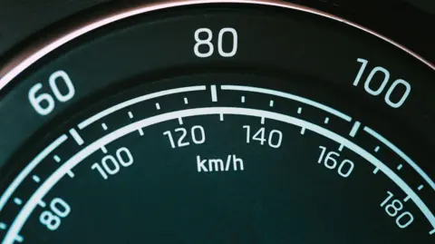 A speedometer showing speeds in miles per hour and kilometres per hour