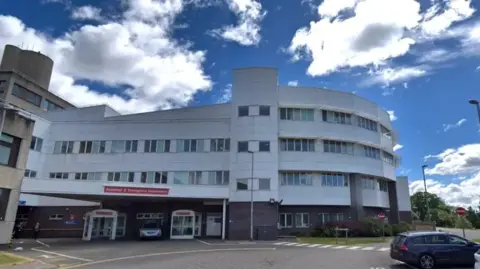 Google A hospital exterior, a large white building with the words Accident and Emergency on a sign
