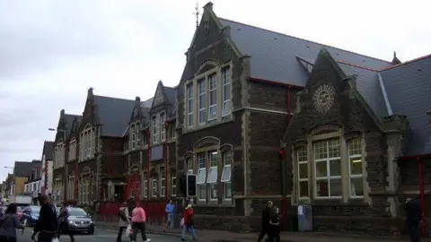 A picture of Albany Road Primary School which has dark stone and large windows 