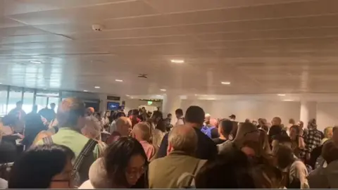 Long queues through security at Manchester Airport