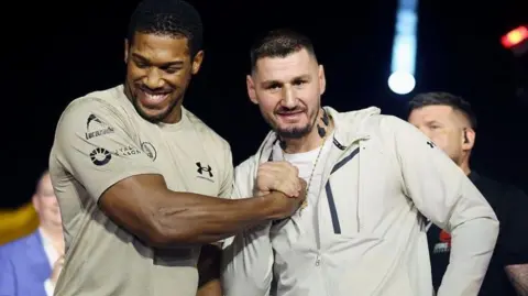 Anthony Joshua and Kristian Prenga shake hands