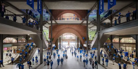 Birmingham City La entrada sur del estadio es luminosa y luminosa, con una galería central y escaleras que sirven a varios niveles en los lados izquierdo y derecho. Se puede ver gente caminando en todos los niveles, algunos en lo que parecen tiendas más a izquierda y derecha.