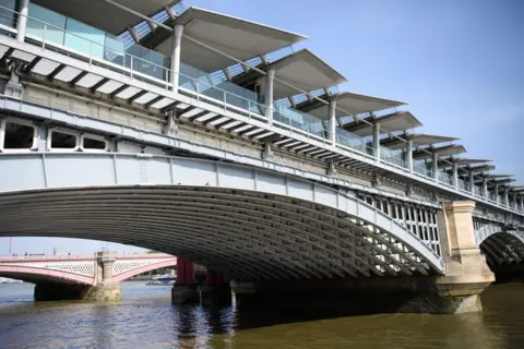 Getty Images The panelled roof of Blackfriars Bridge, currently the world's largest solar-powered bridge, is seen from the south bank of the River Thames on July 4, 2017 in London, England.