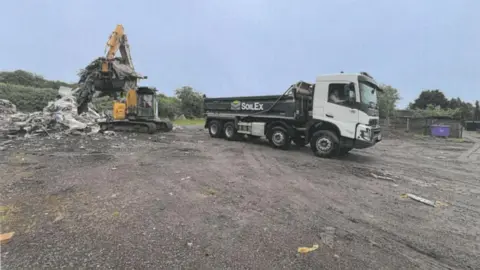 Environment Agency/SoilEx A digger loads waste into a SoilEx branded truck