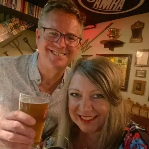 Tamworth Borough Council George and Louise Greenaway smiling at the camera while holding drinks