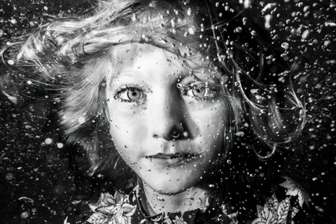 Kerrie Burow/UPY2022 A black and white portrait of a girl underwater