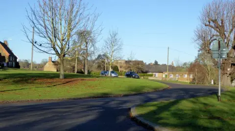 A view of Badby village green on a clear day.